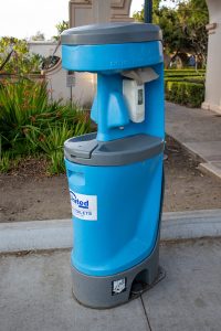 portable hand wash station near the sidewalk